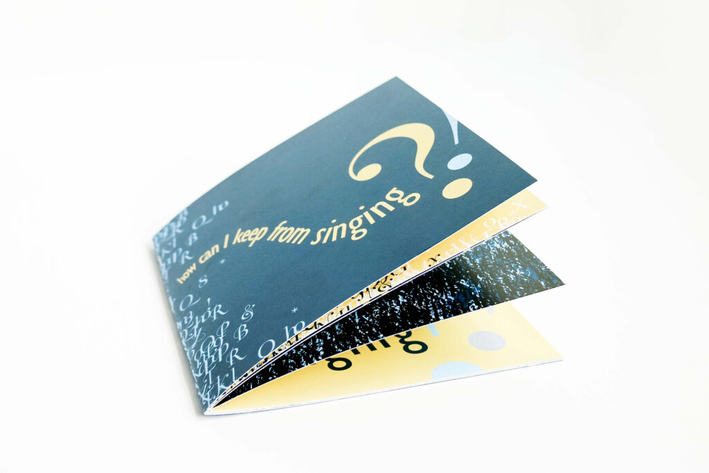 Image of a navy blue booklet with type how can I keep from singing across the front